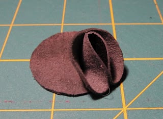 gluing petal on leather circle