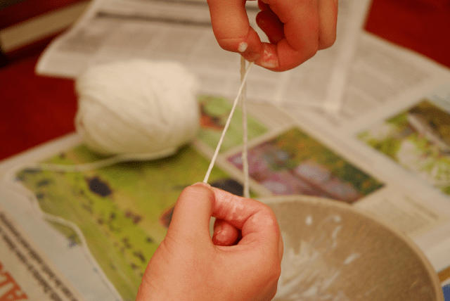 squeezing off excess glue from yarn