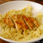 parmesan chicken and buttered noodles in a bowl