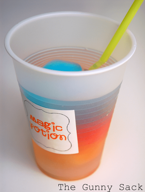 magic potion rainbow drink drink in a plastic cup with a straw