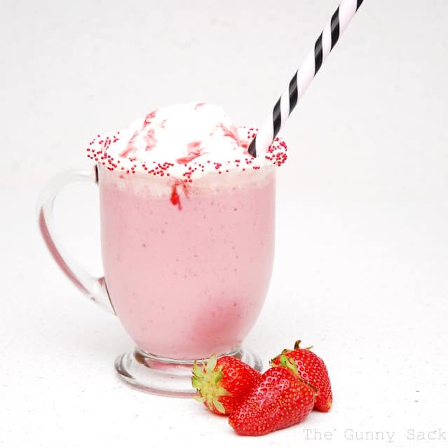 strawberry cheesecake shake in a cup with a straw