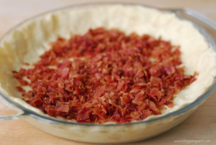 bacon crumbles on crust in pan