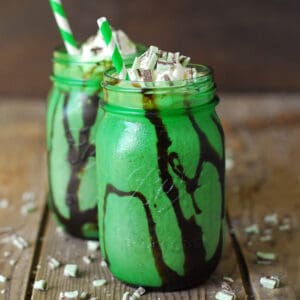 Chocolate mint milkshake in a green mason jar.