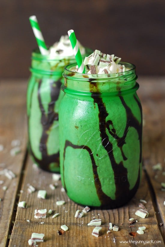 mocha mint milkshake in a green mason jar with whipped cream and a straw