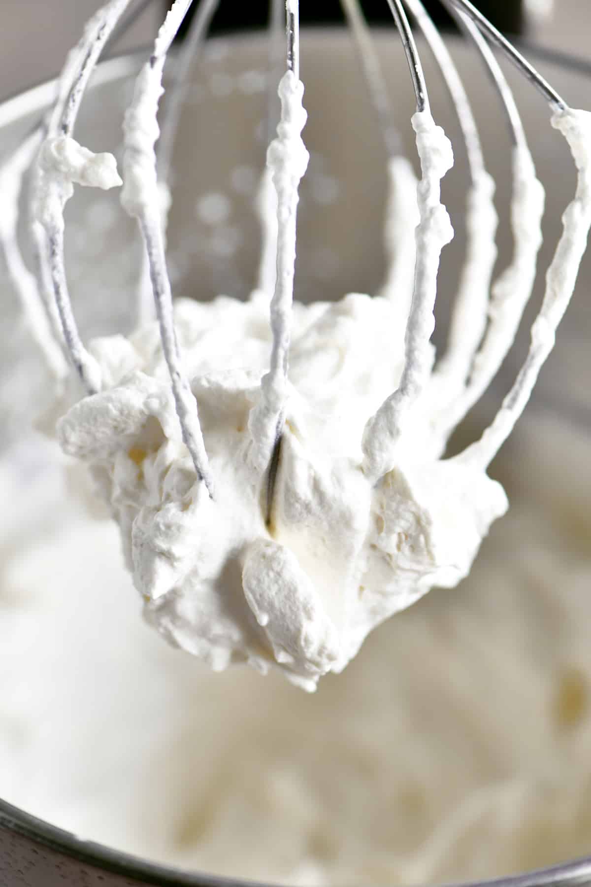 Maple whipped cream on a wire whisk.