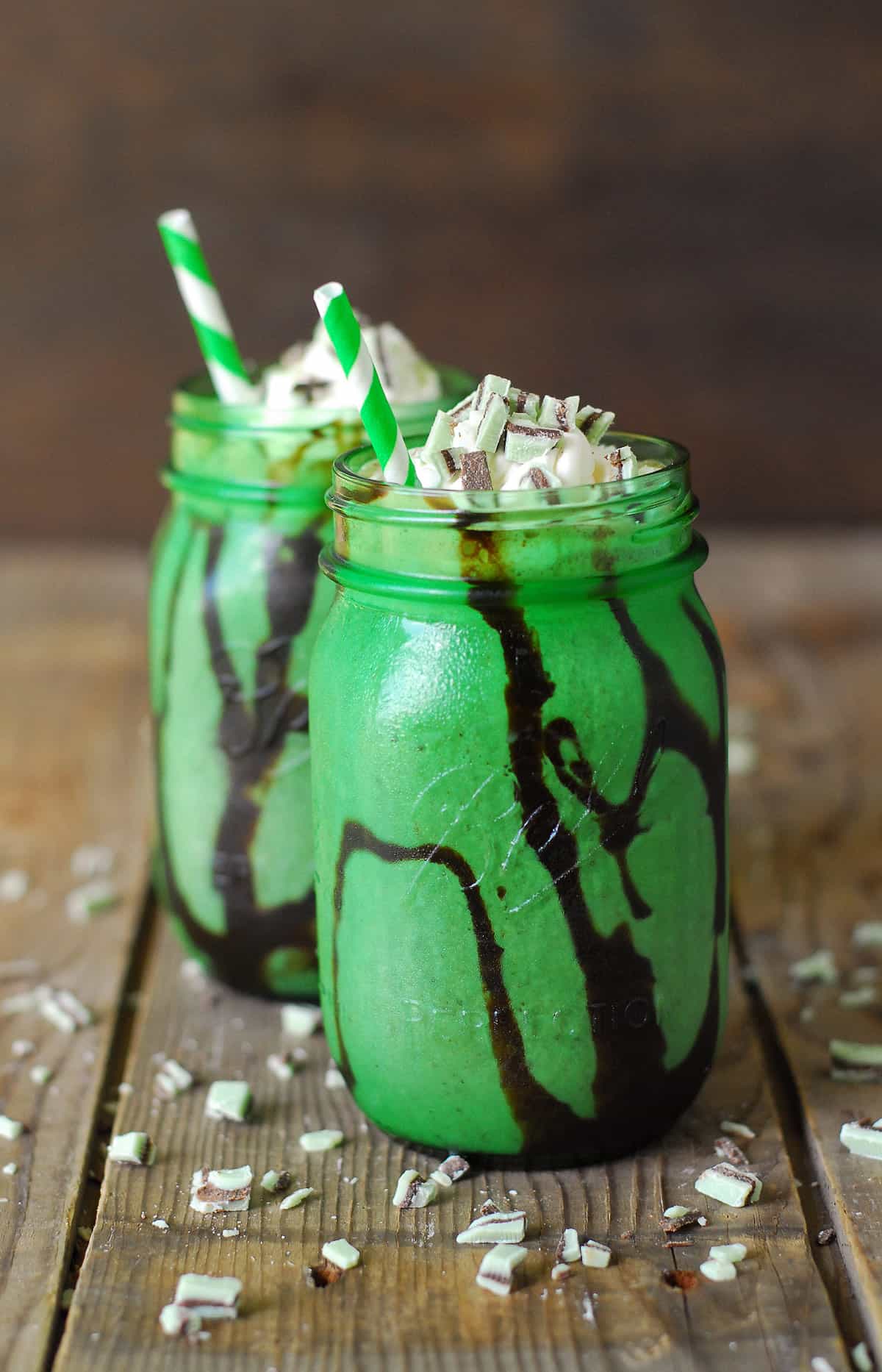Mocha mint milkshake in a mason jar with a straw.