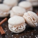 Eggnog Macarons with cinnamon sticks and powdered sugar