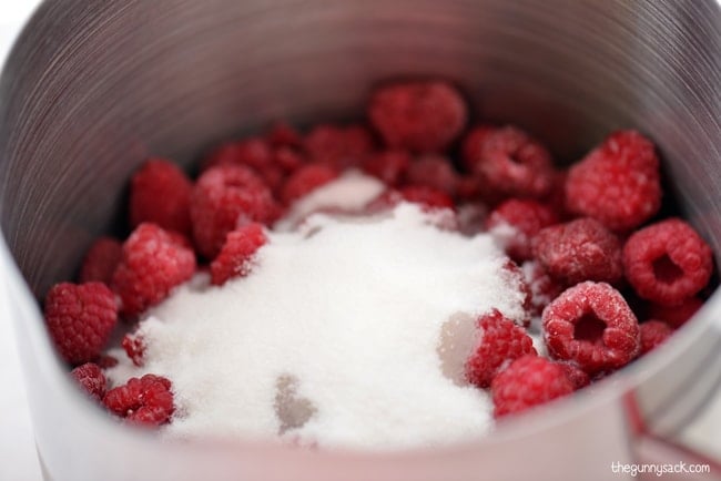 raspberries and sugar in a sauce pan