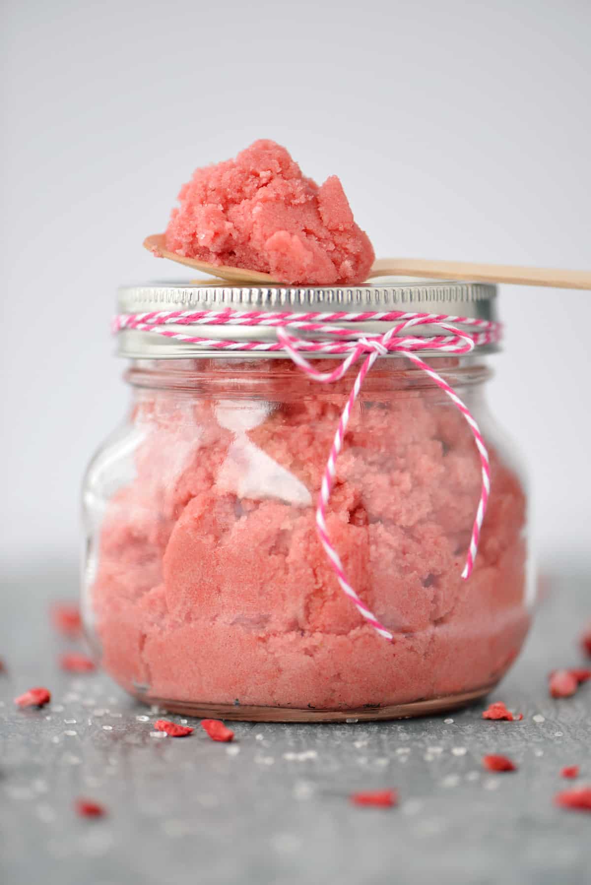 A mason jar filled with strawberry sugar scrub.