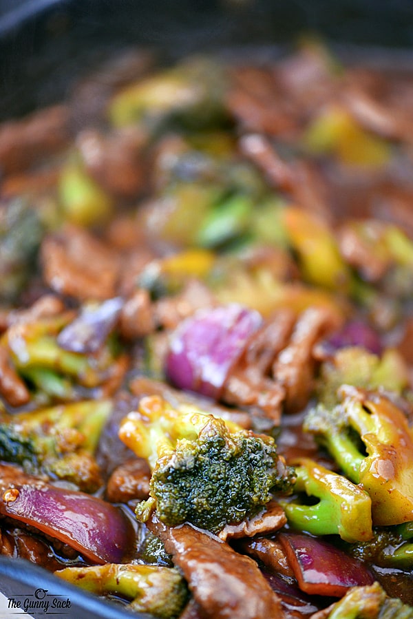 beef and broccoli cooking in a skillet
