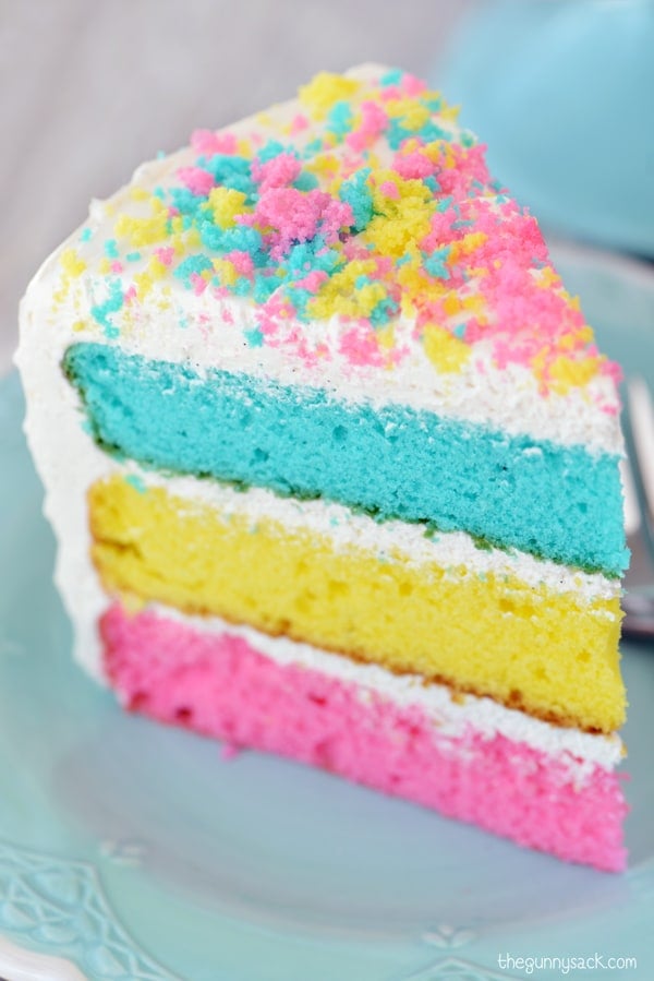 a slice of multi colored Easter cake on a plate