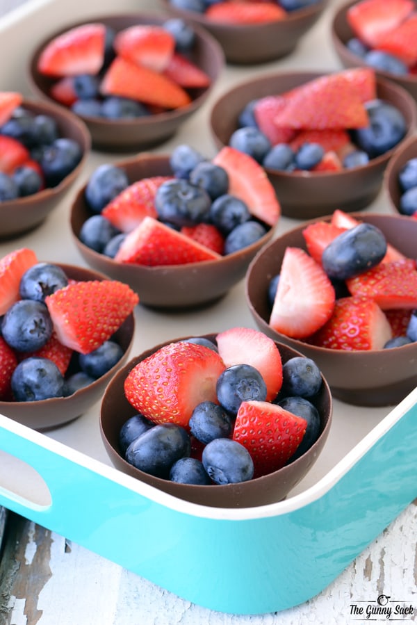 strawberries and blueberries in chocolate bowls