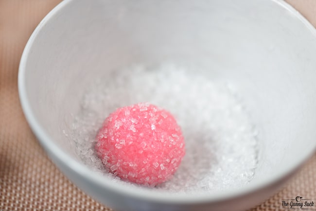 coat dough balls with sugar