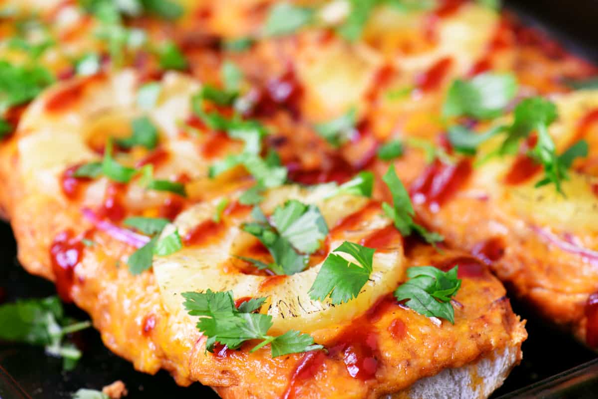 Side view of baked Hawaiian barbecue French bread pizza.