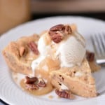 cookie bar slice with ice cream on white plate