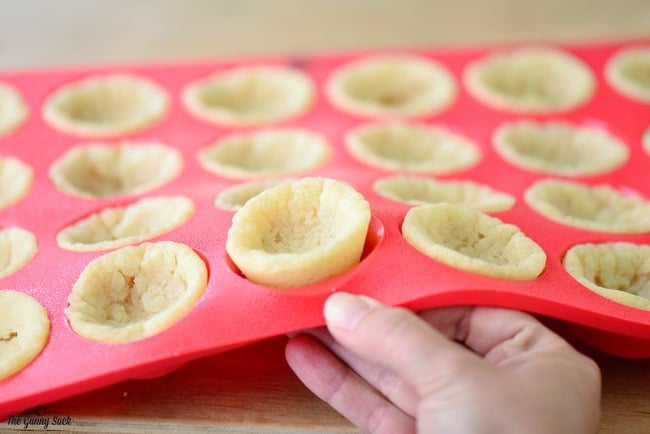 Cookie Cups Being Popped Out Of The Silicone Pan