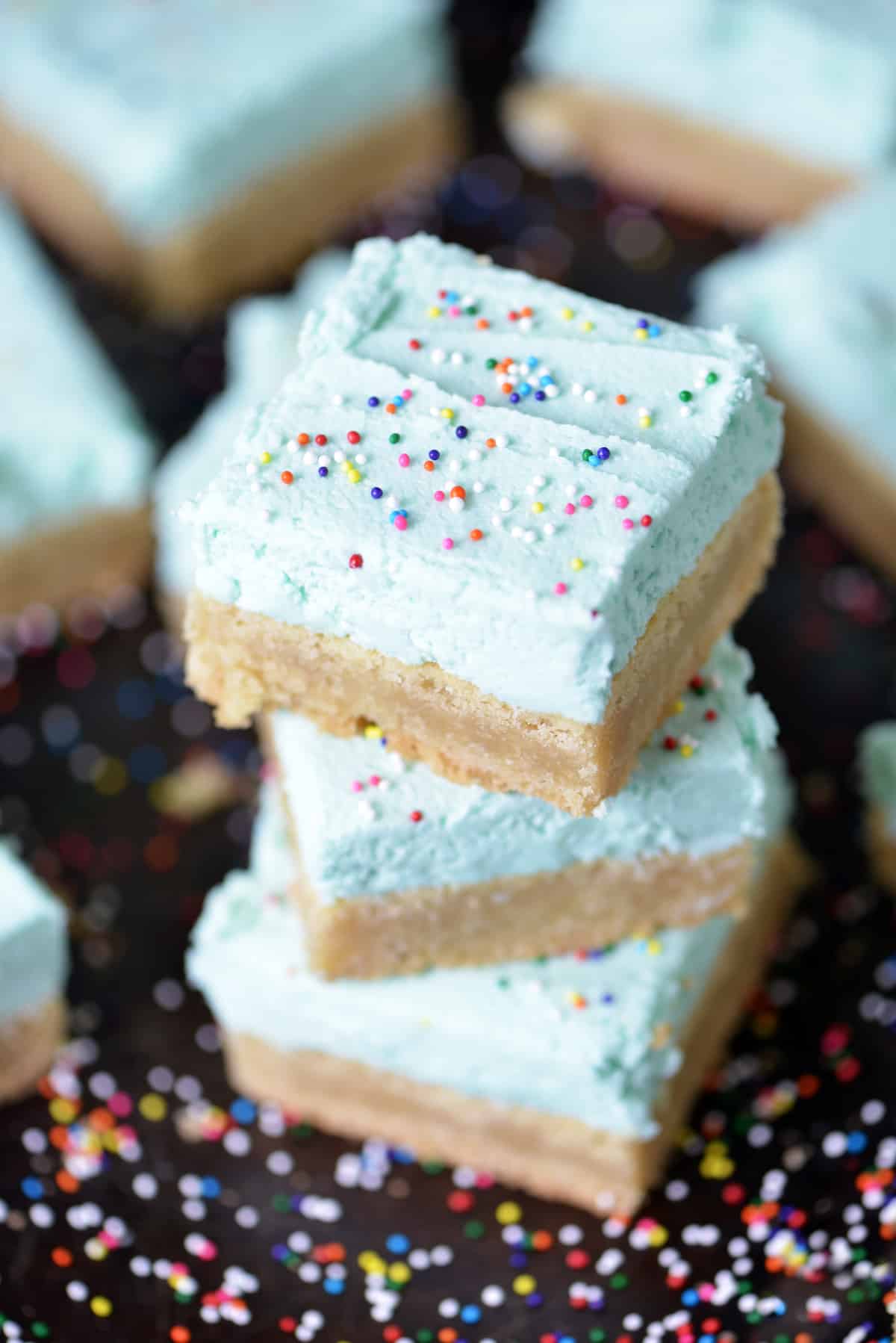 A stack of frosted sugar cookie bars.