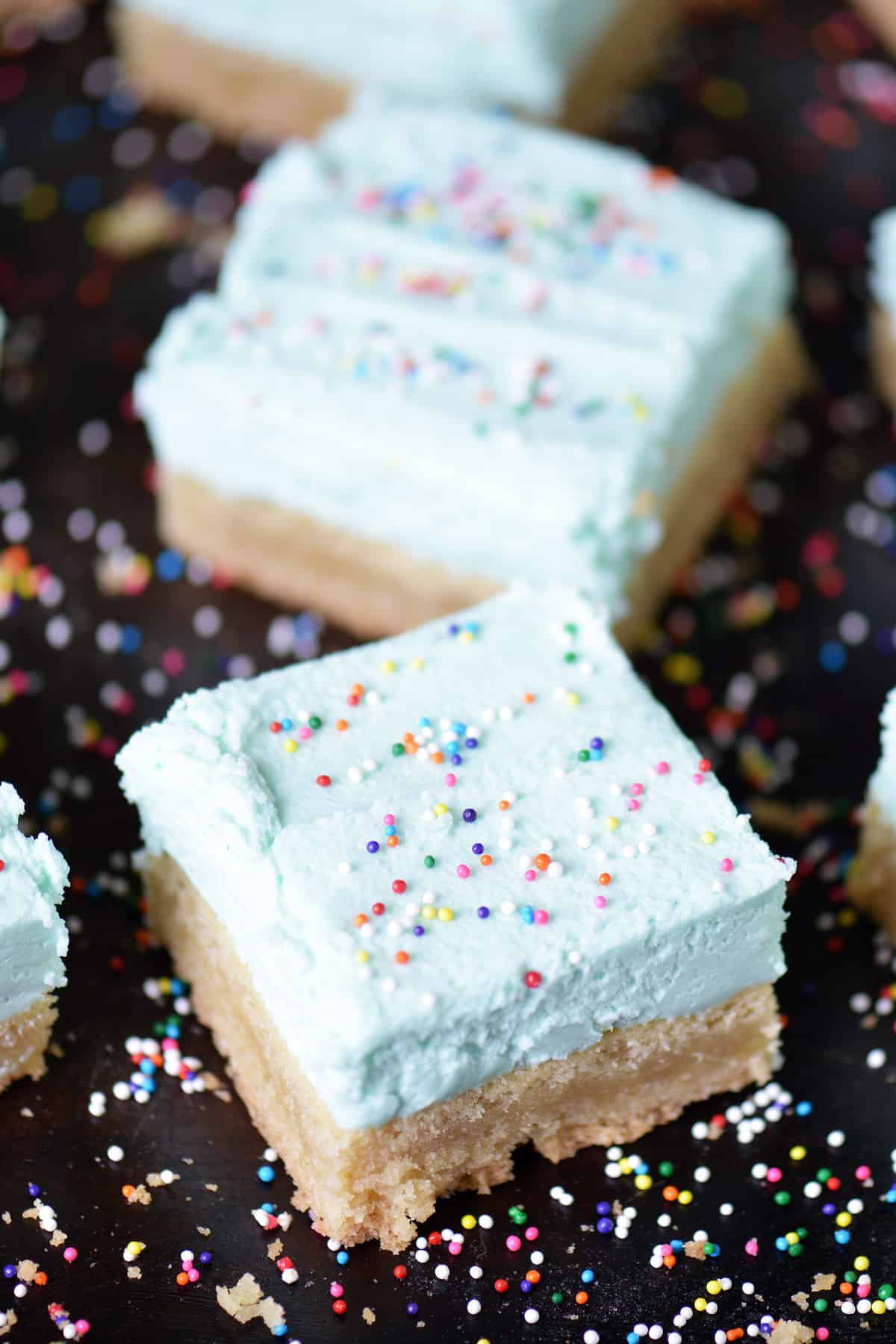 Sugar cookie bars with buttercream frosting and sprinkles.