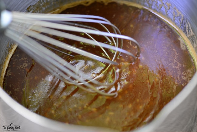 whisking thickened stir fry sauce in saucepan