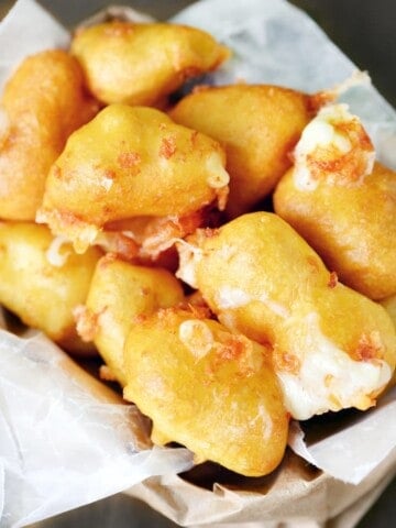 Deep fried cheese curds on parchment.