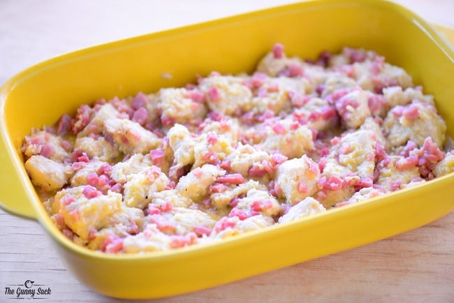 Ham Egg and Cheese Breakfast Biscuit Casserole in yellow dish