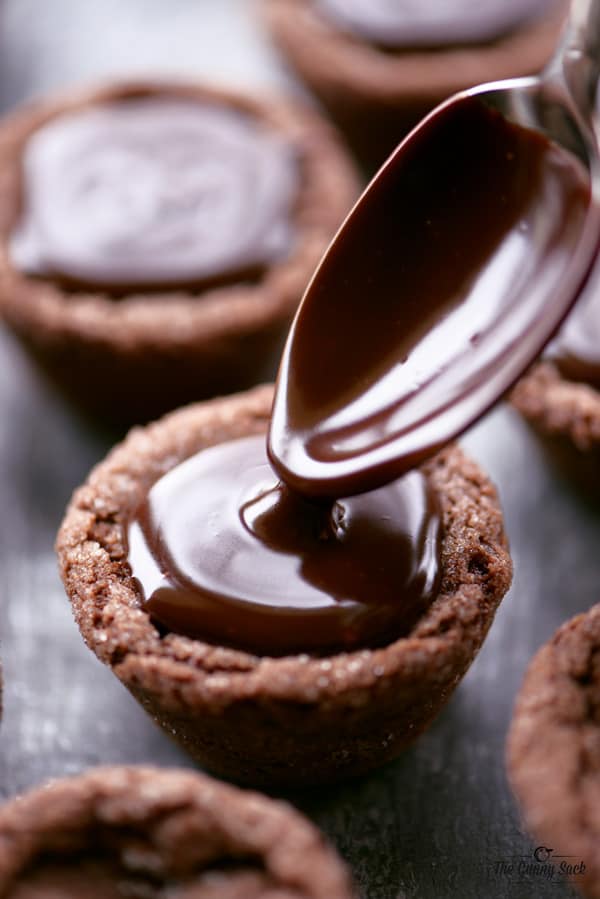 peppermint ganache spooned into peppermint hot chocolate cookie cups