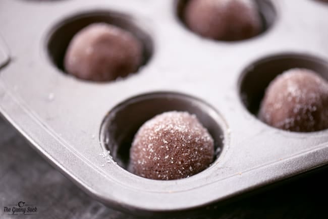 peppermint hot chocolate cookie cups dough balls in a mini muffin pan