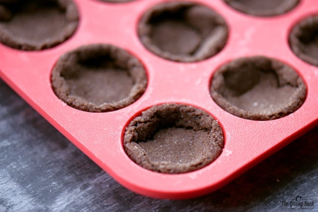 baked peppermint hot chocolate cookie cups in silicone pan