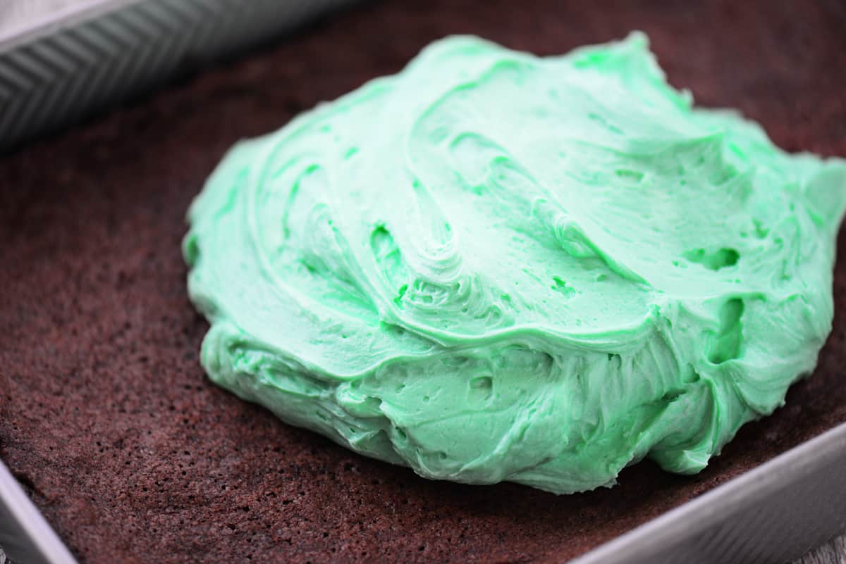 Mint buttercream frosting on brownies.