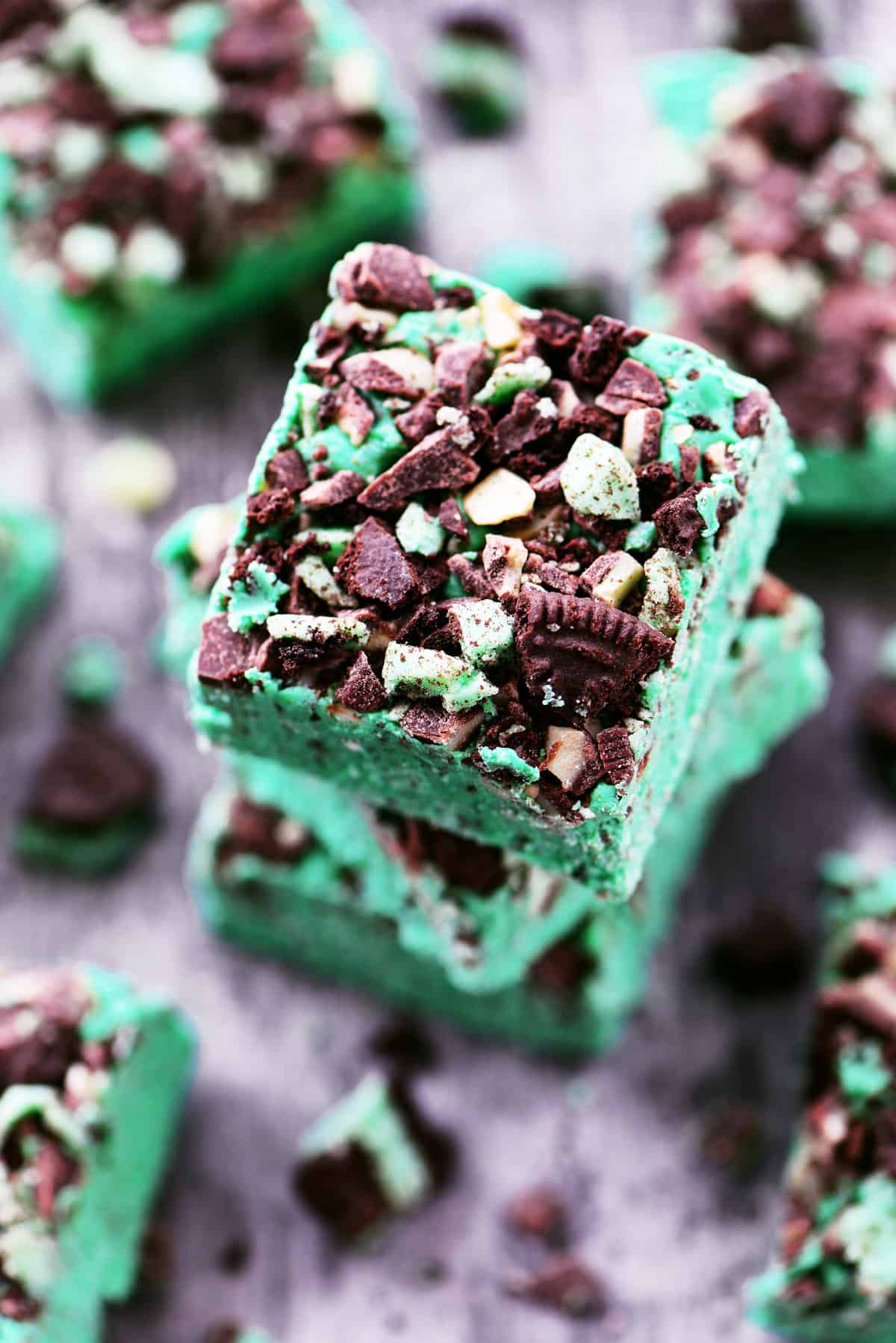 Mint chocolate fudge squares in a stack.