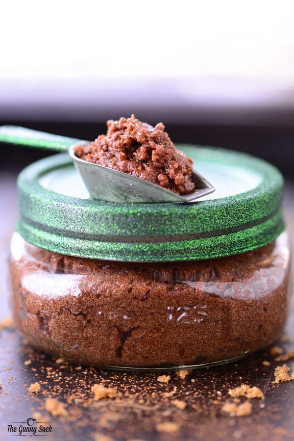 scoop of chocolate mint sugar scrub on top of mason jar filled with scrub
