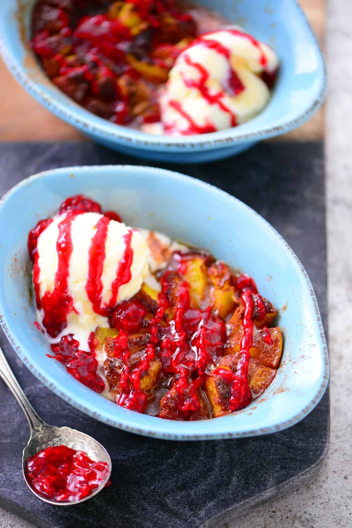 baked blooming peach with raspberry sauce and ice cream