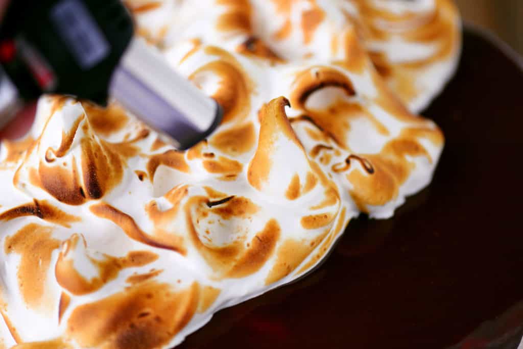 meringue topping being torched to look like toasted marshmallow