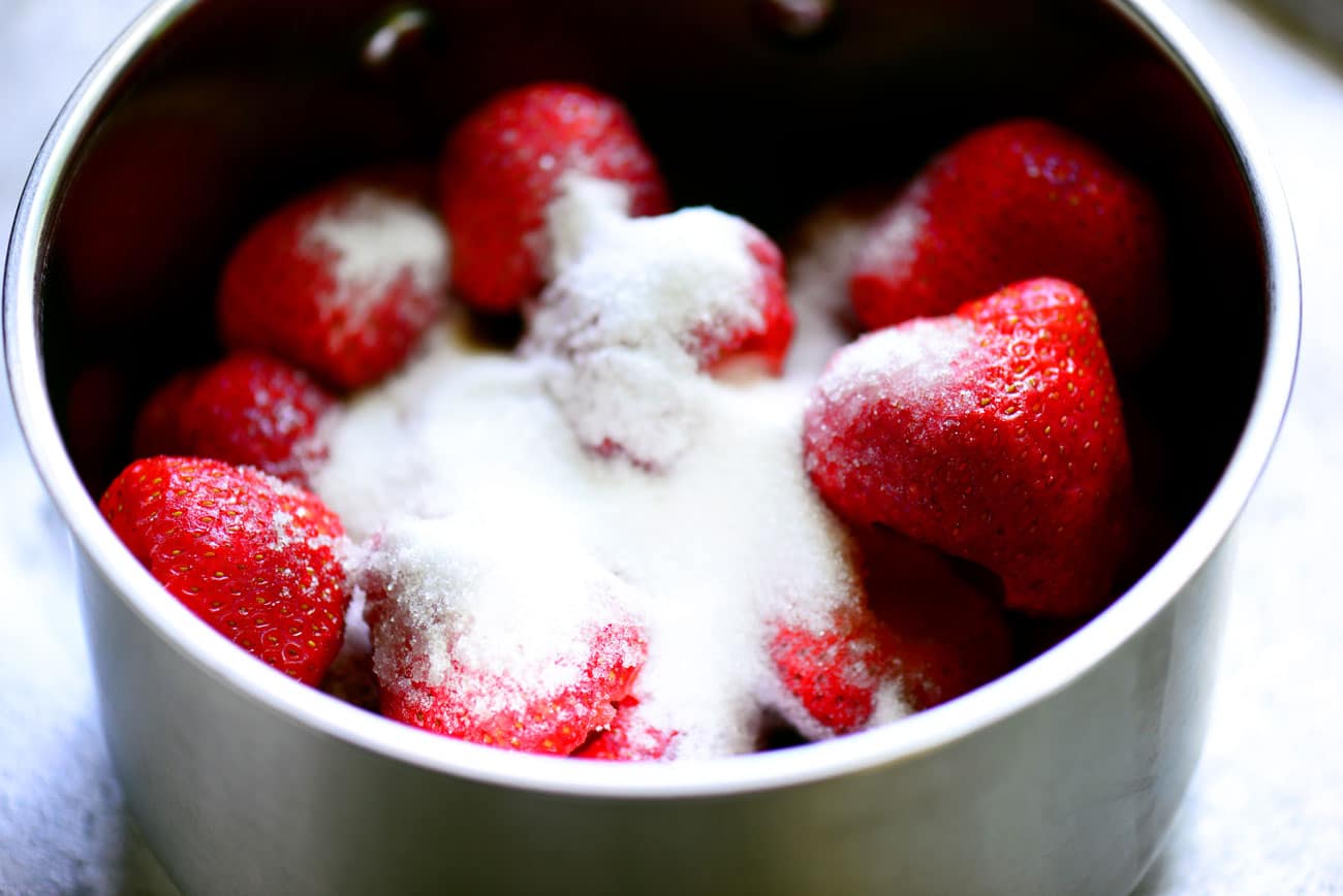 strawberries with sugar in a sauce pan