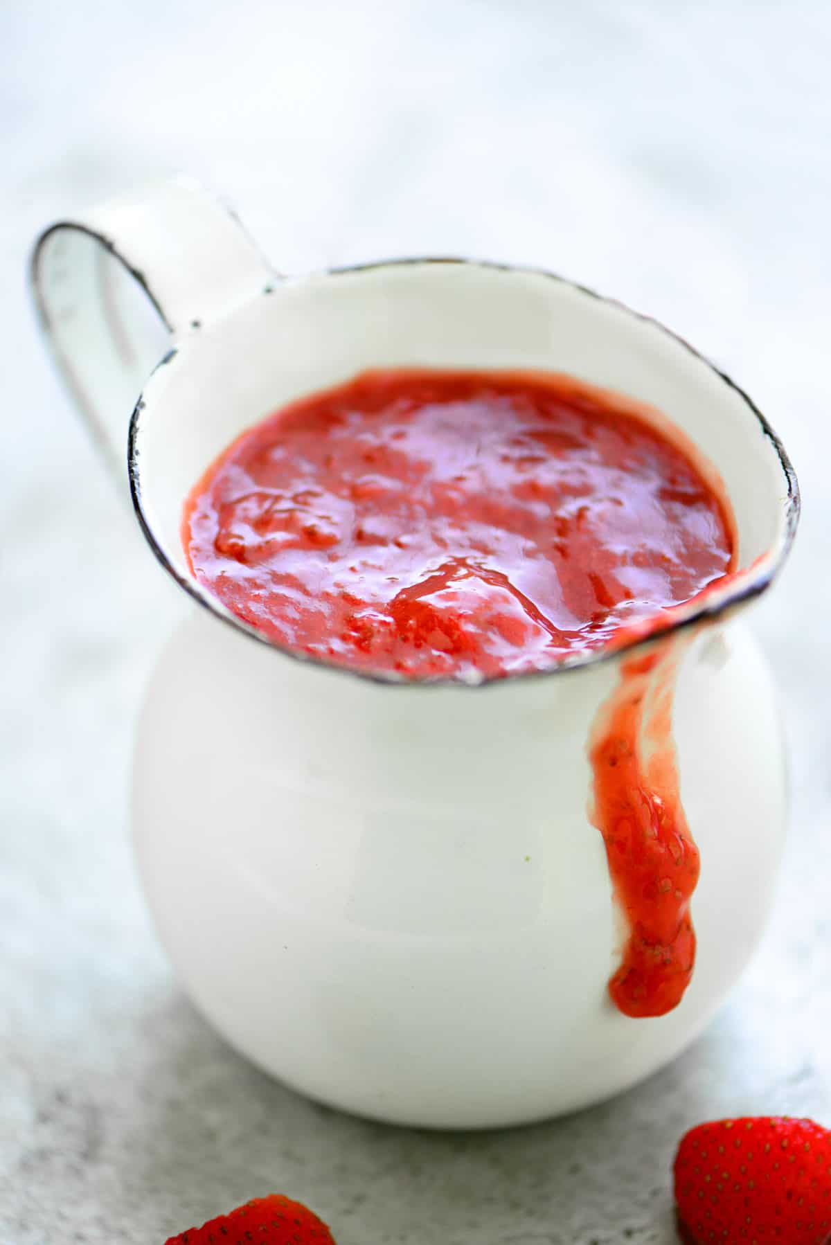 strawberry sauce in a white pitcher