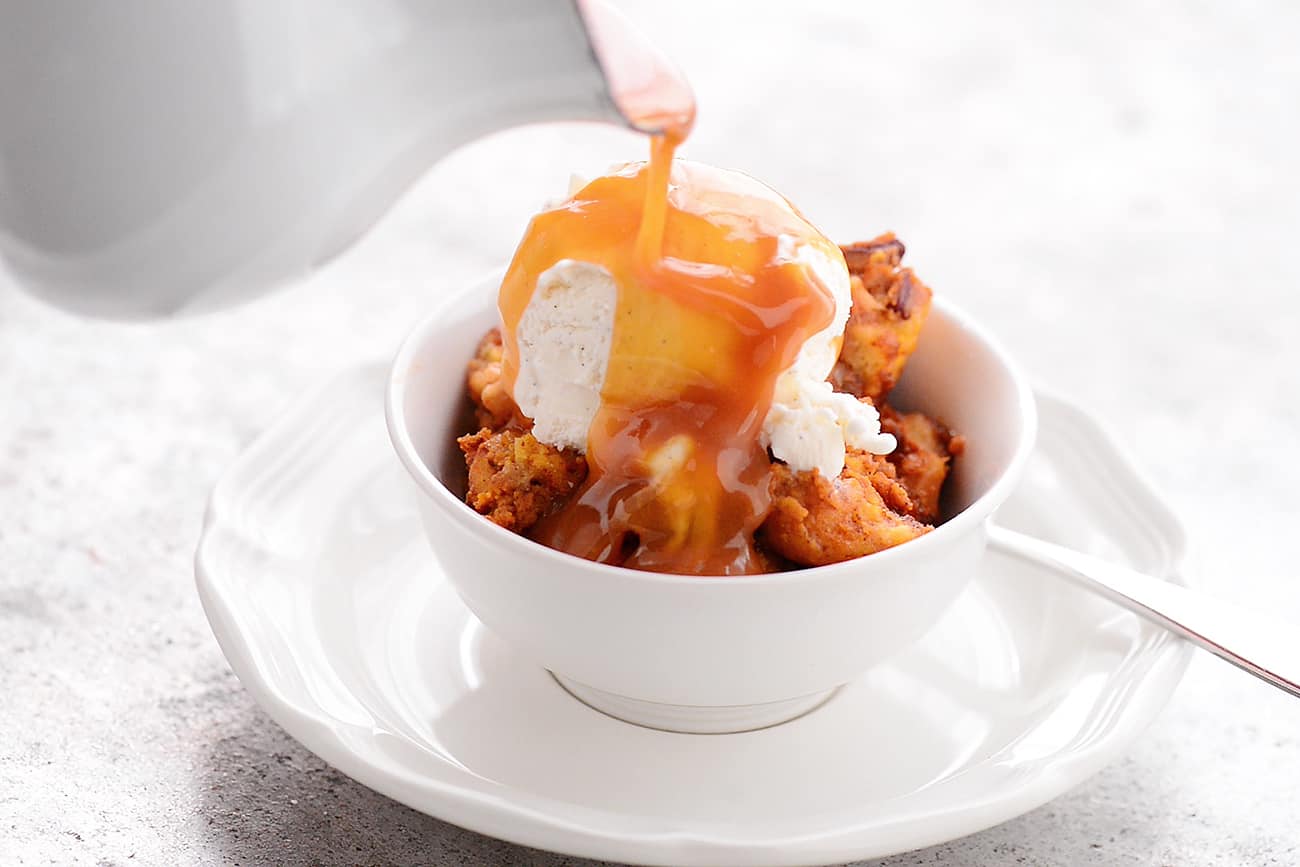 slow cooker pumpkin pecan bread pudding with ice cream and caramel sauce