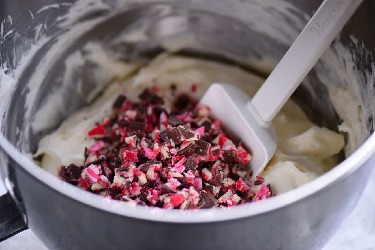 peppermint bark being mixed into the cream cheese filling