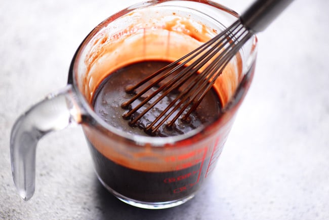 chocolate ganache in a liquid measuring cup with a spout