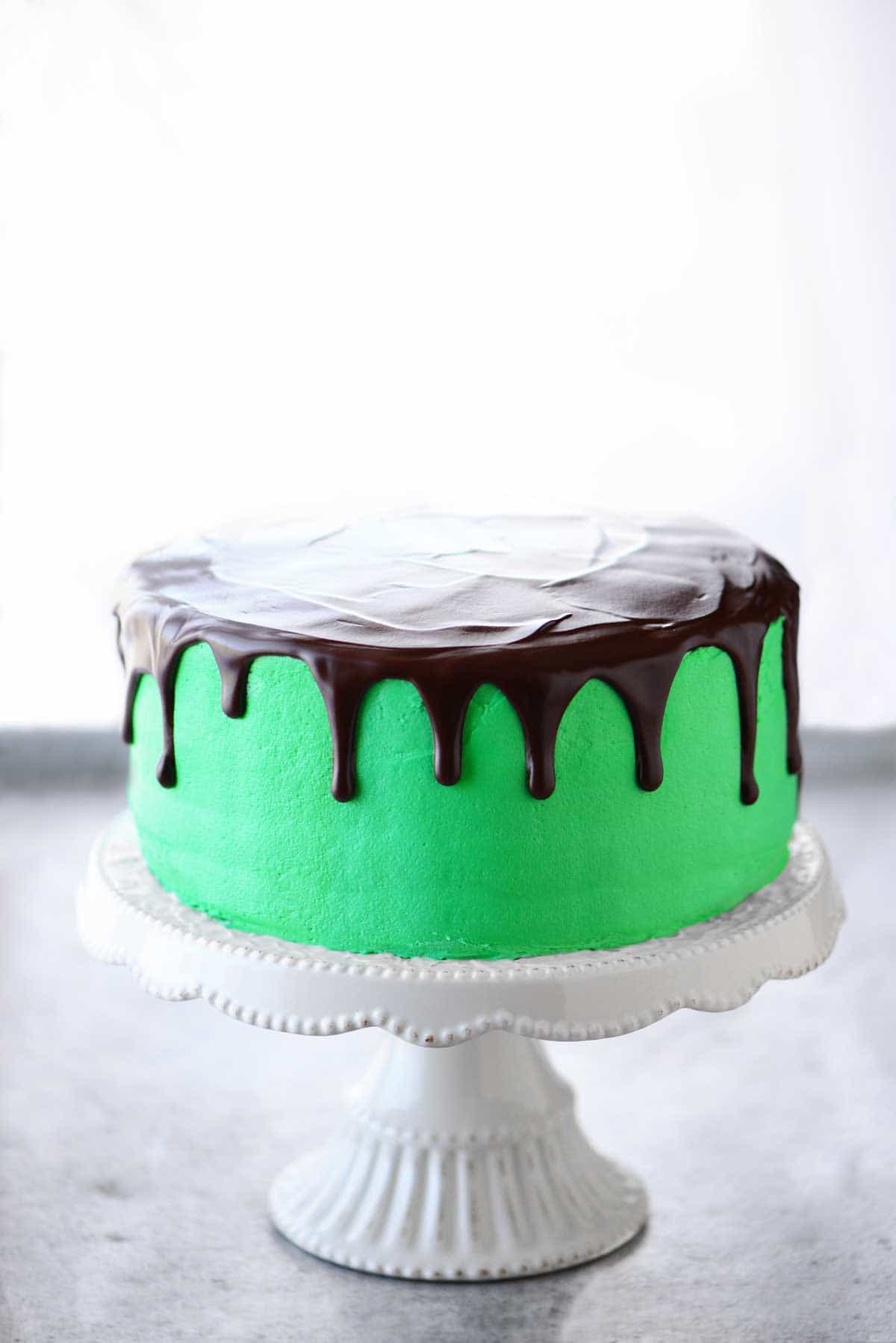 green chocolate mint layer cake with a chocolate drizzle