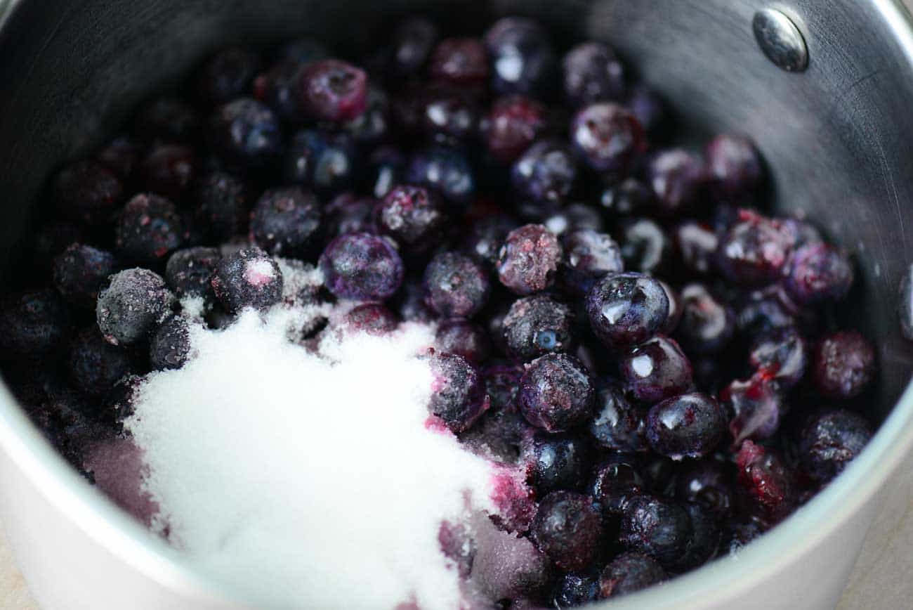 berries and sugar in a saucepan