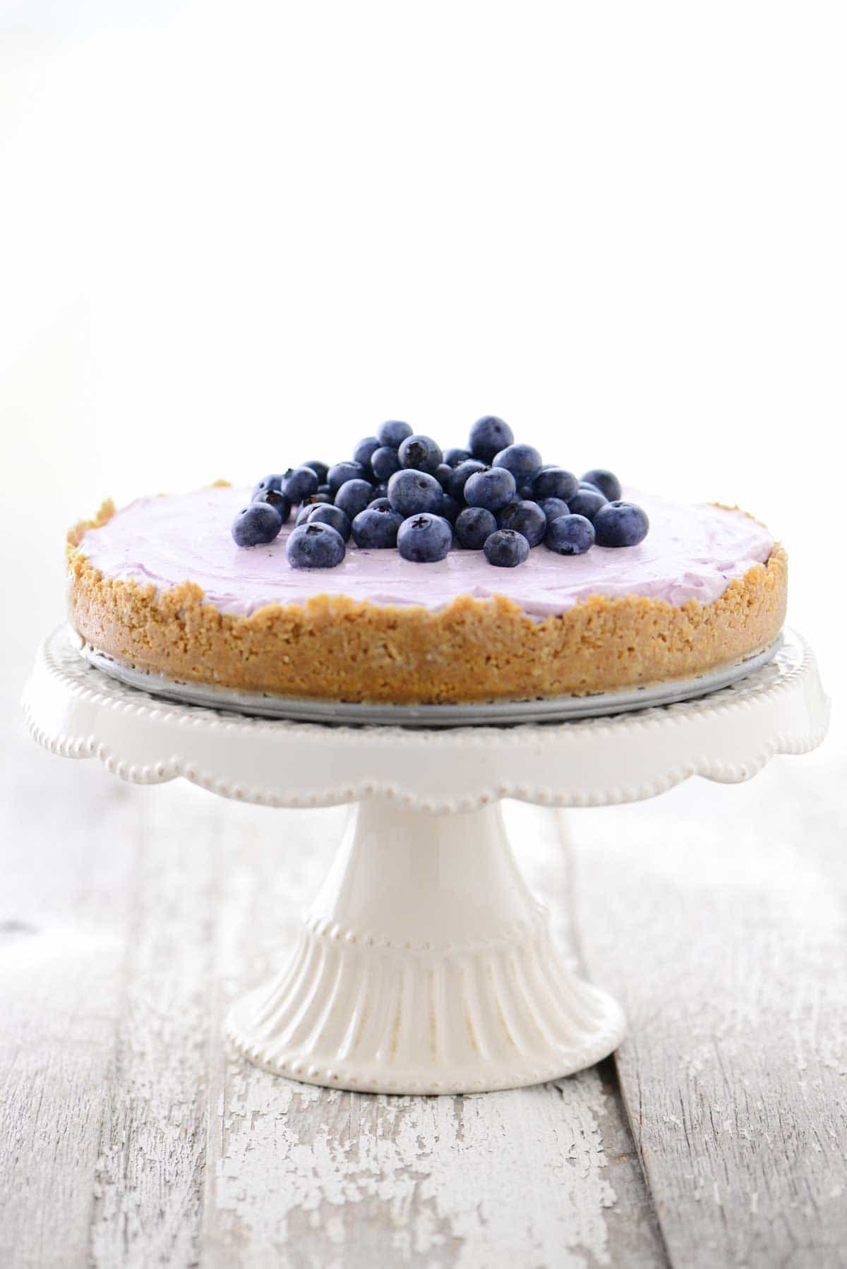 No Bake Blueberry Cheesecake on cake stand