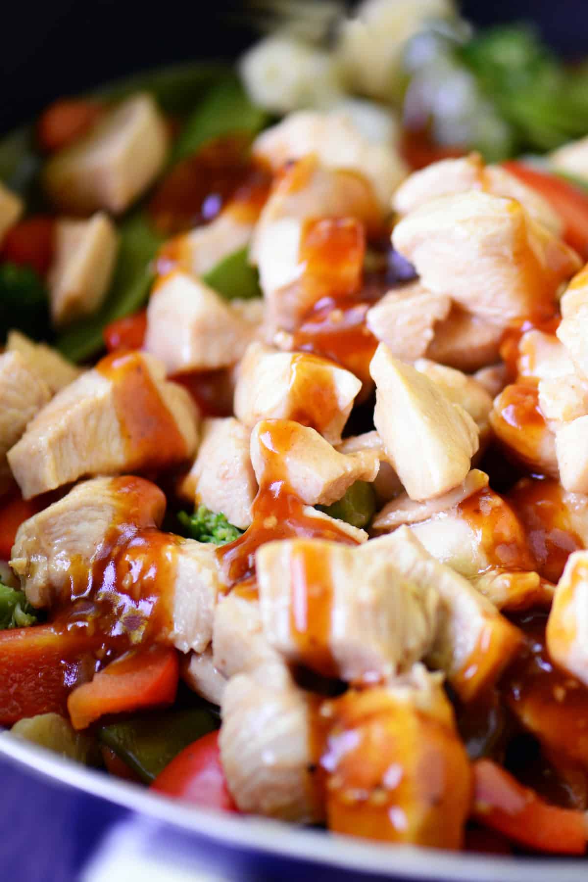 Stir fry sauce drizzled on chicken and veggies.