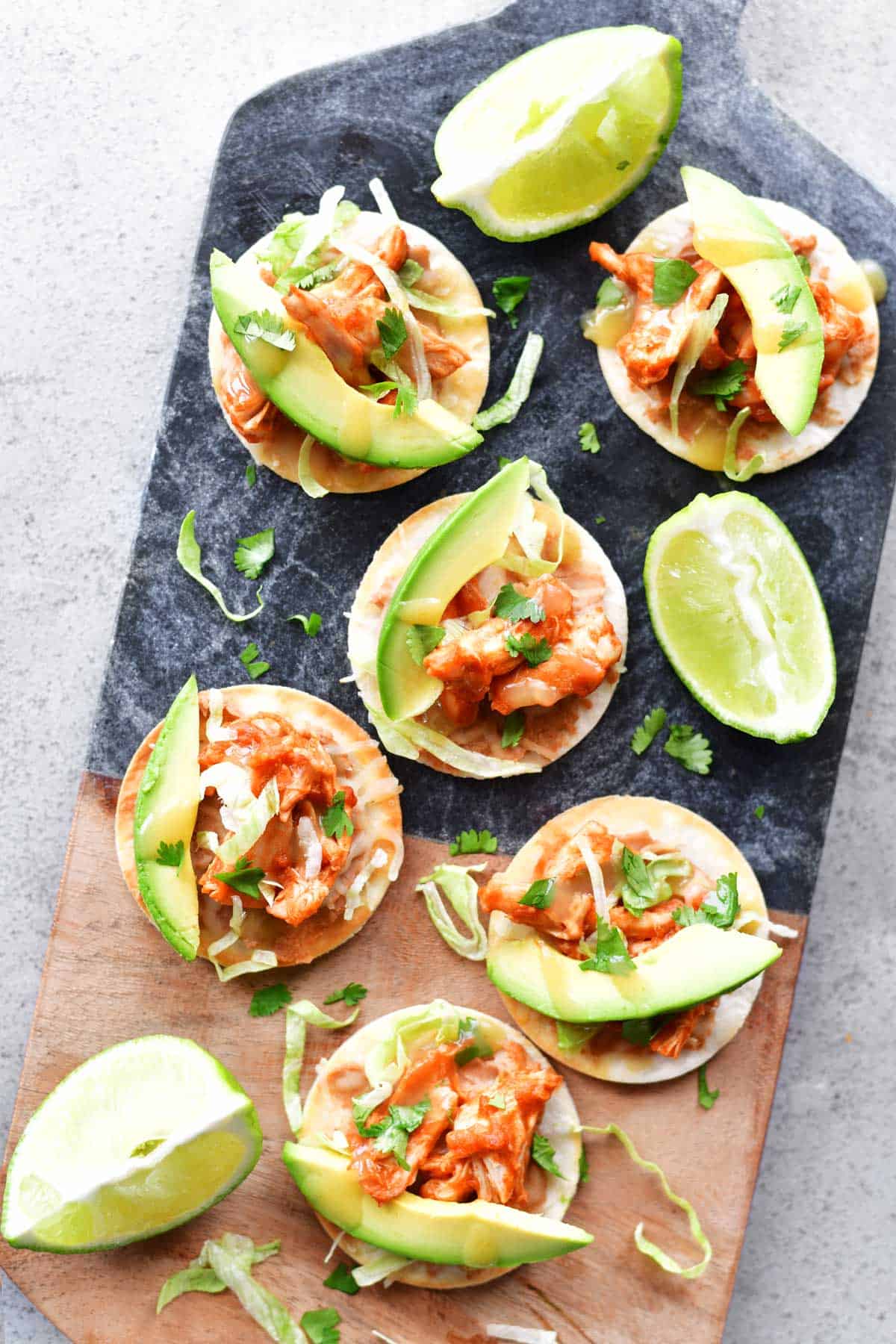 lime drizzled on mini chicken taco pizzas