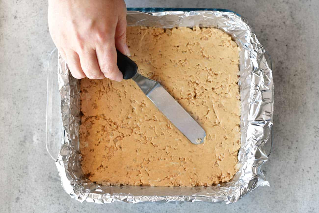smooth peanut butter bars with an offset spatula