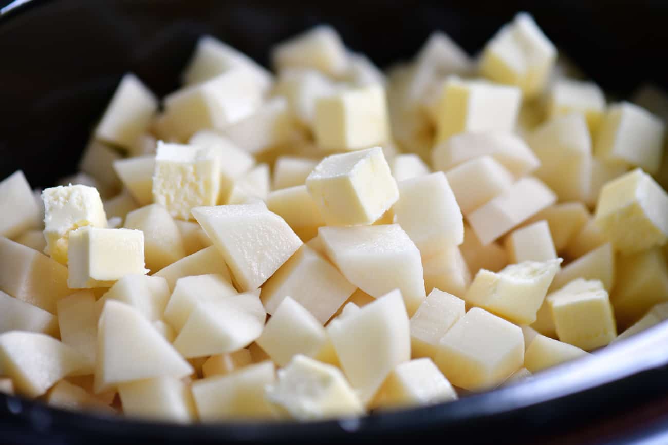 add butter cubes to diced potatoes