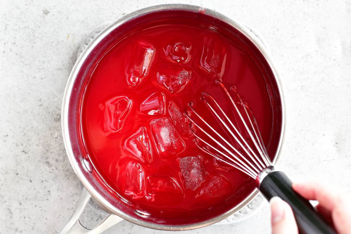 add ice to strawberry jello in saucepan to thicken
