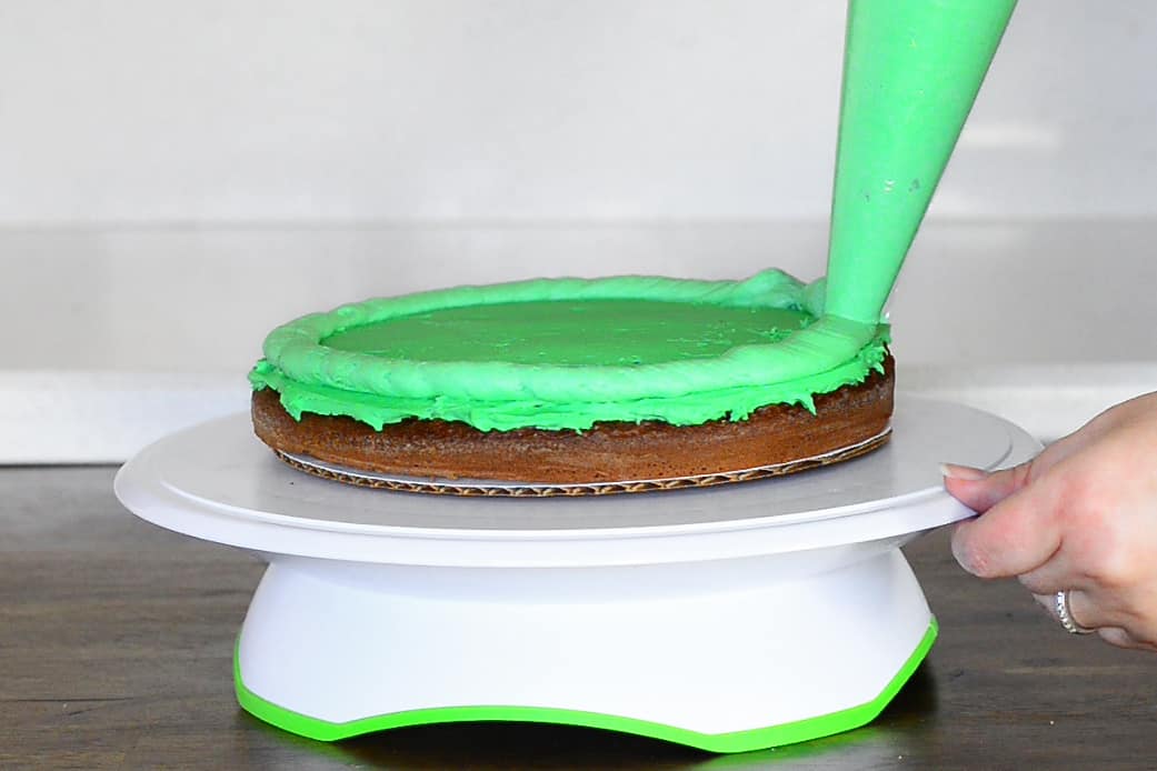 make a frosting barrier around the top of the bottom layer