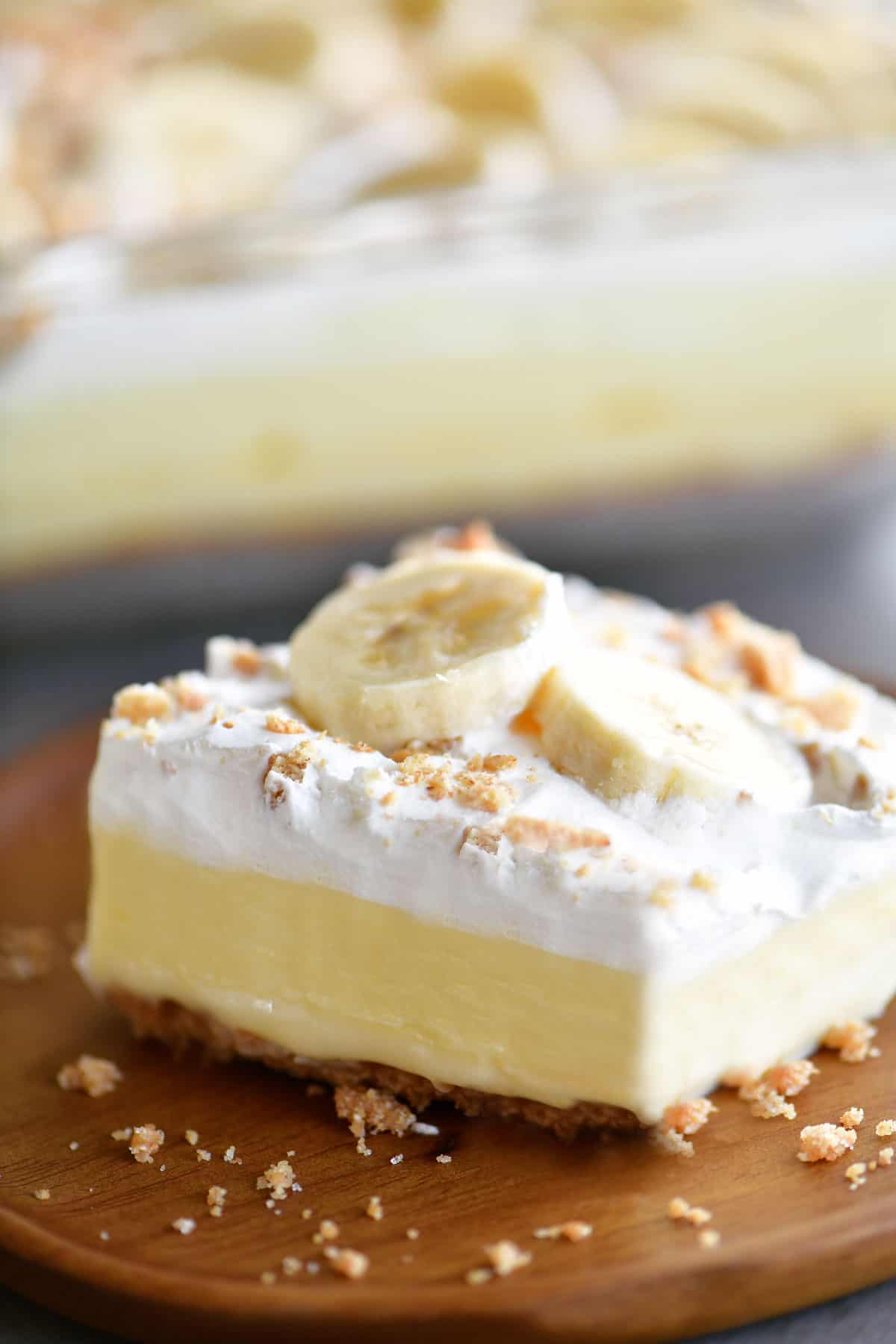 slice of banana cheesecake dessert on wood plate