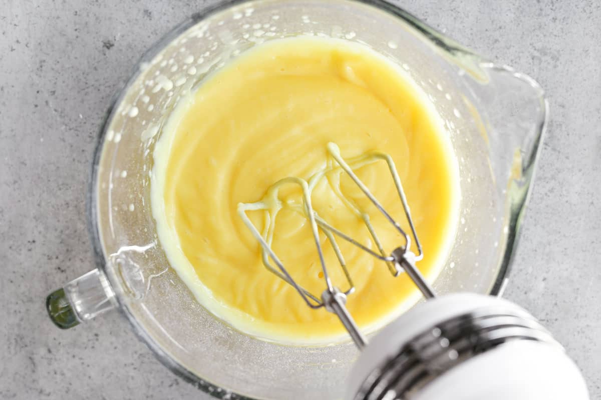 beating banana cream pudding in glass bowl