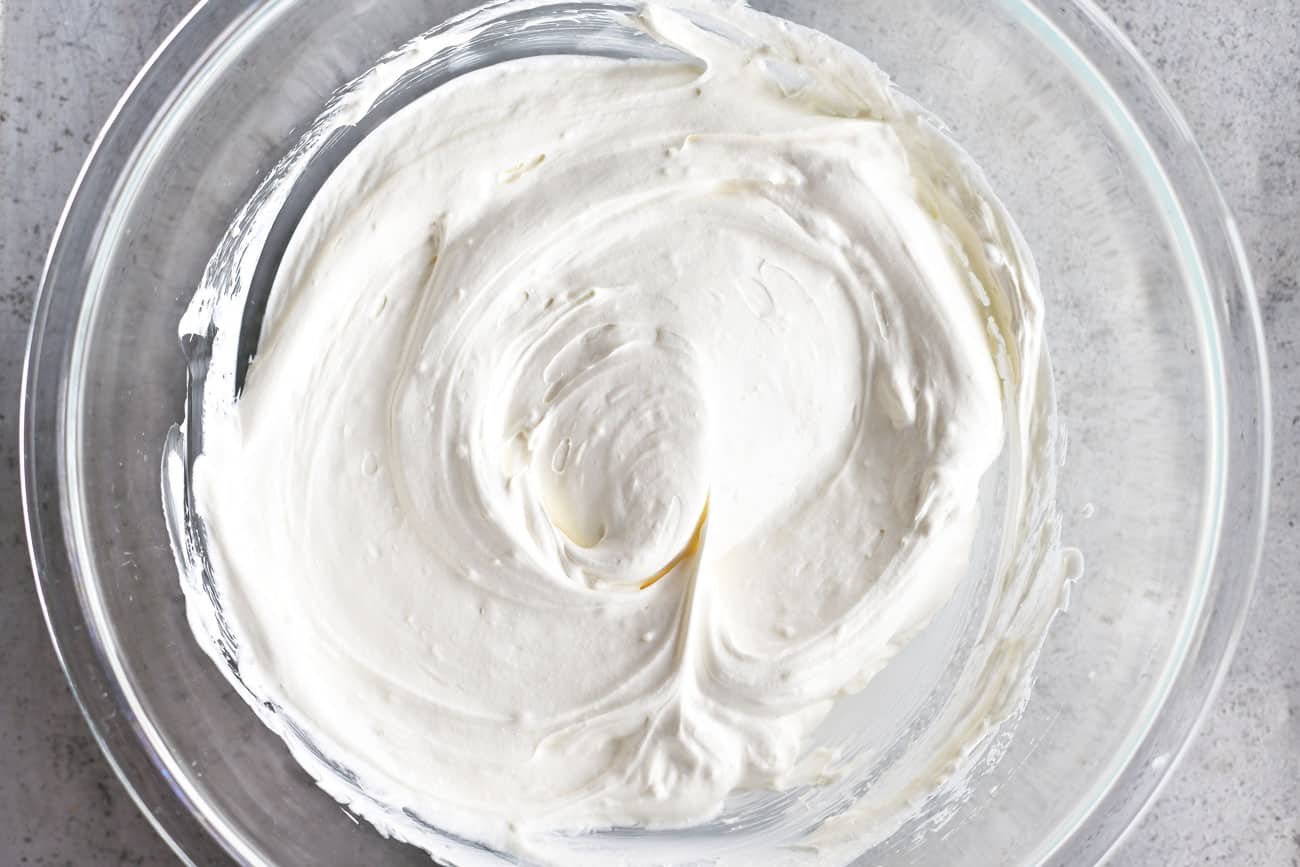 cool whip stirred into cream cheese mixture in a glass bowl